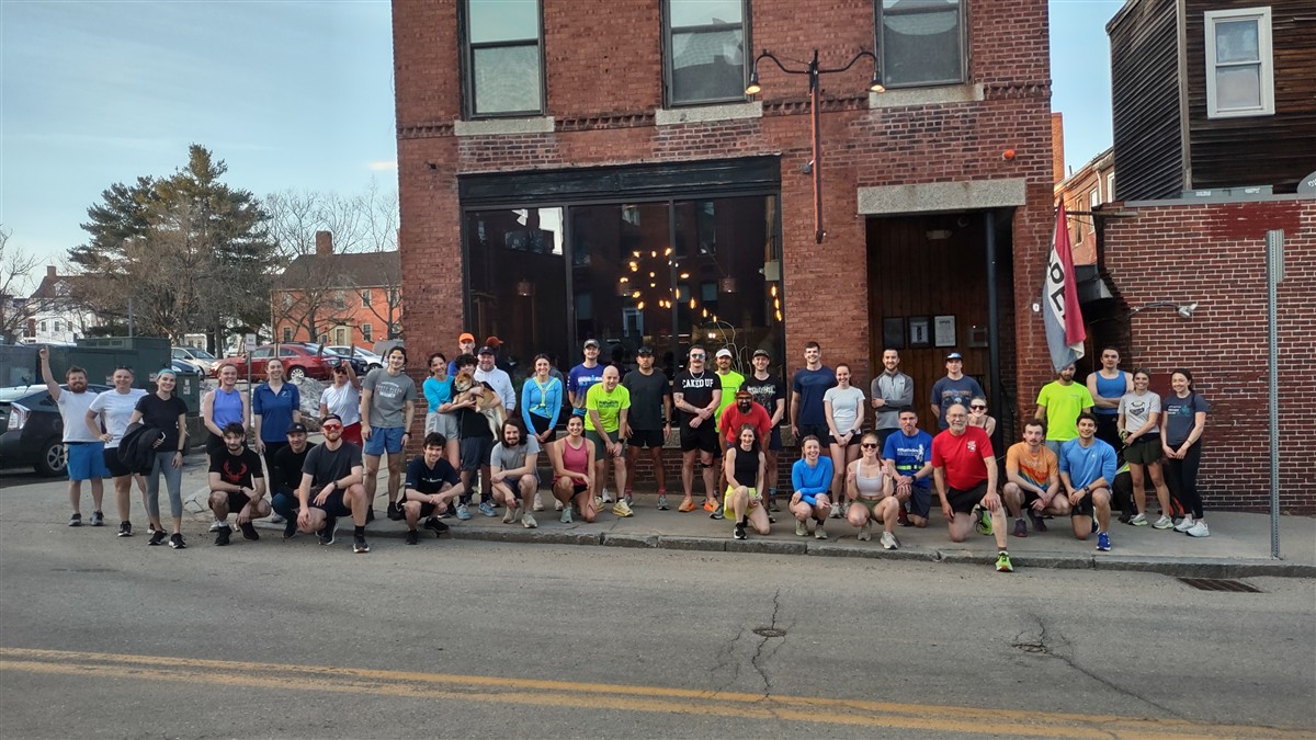 Large group of runners smiling outside The Brick